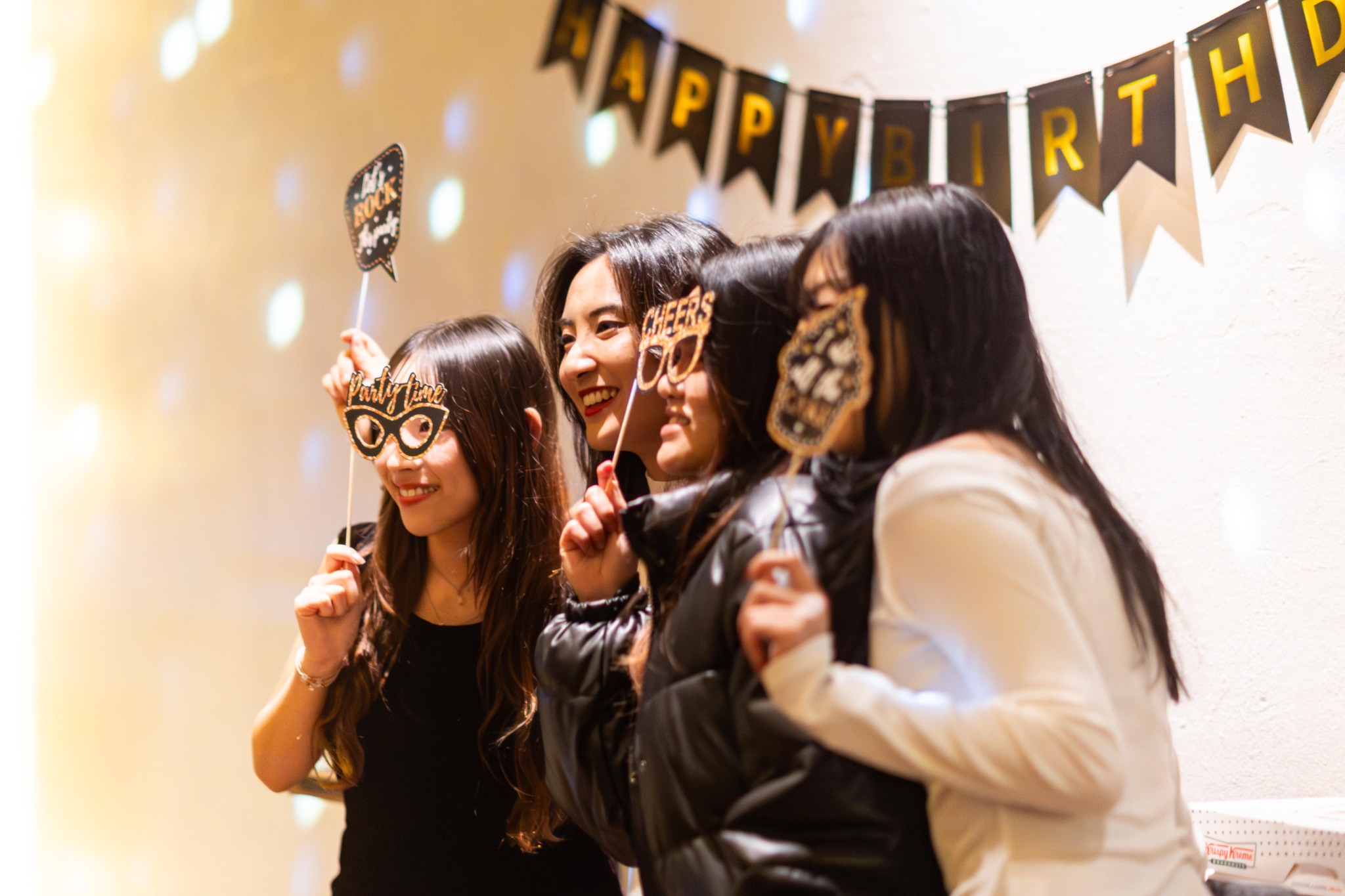 Guests posing by the birthday decorations
